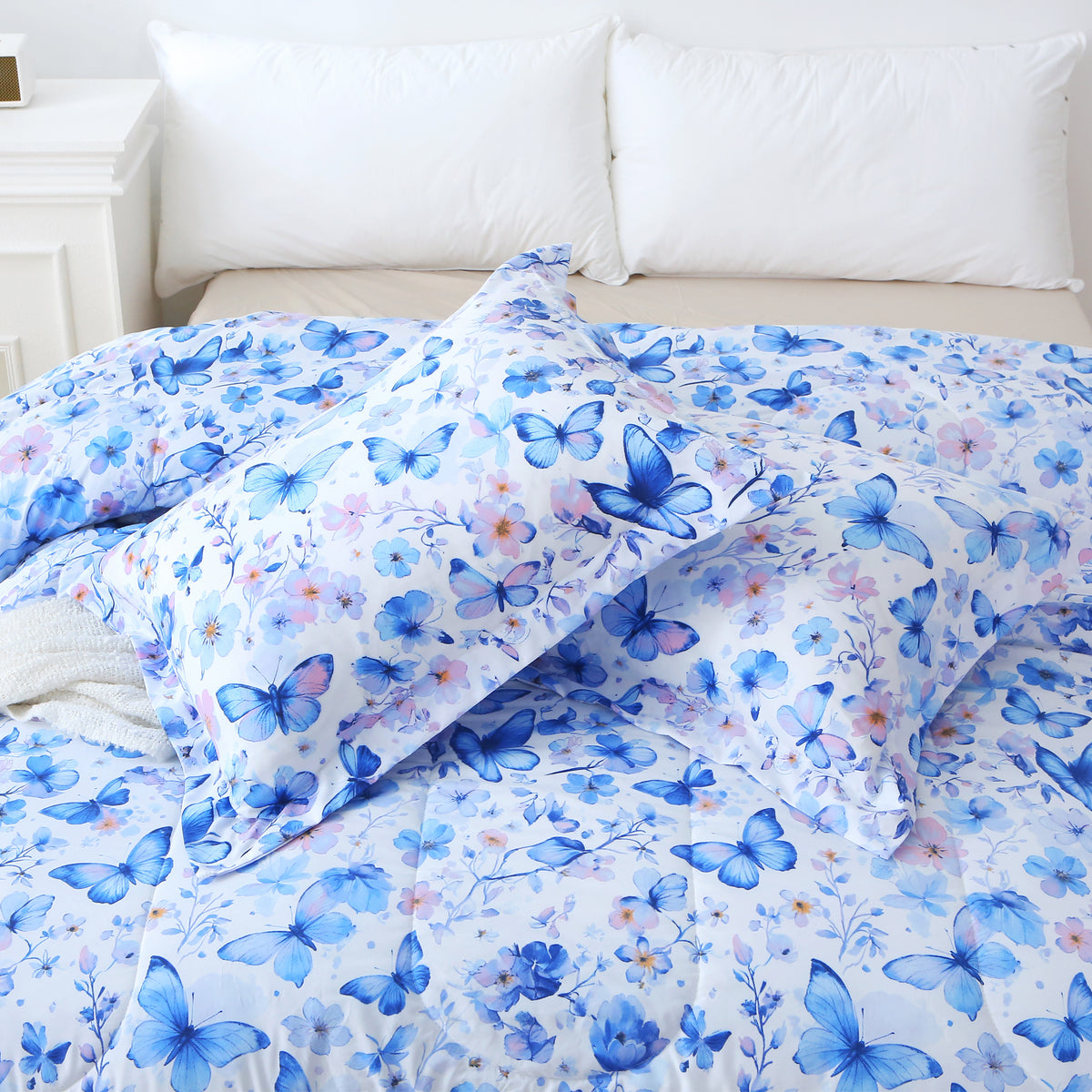Matching Violet Butterfly pillow shams resting on the comforter