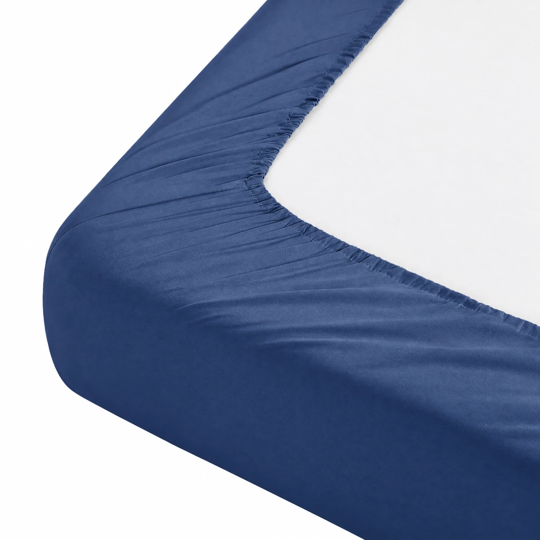 The elastic edge and stitching of the Navy fitted sheet