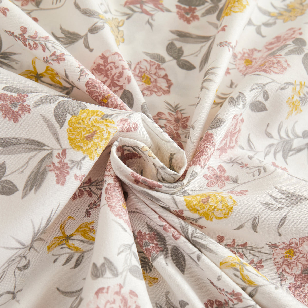 Close view of the pink and yellow floral sheet fabric